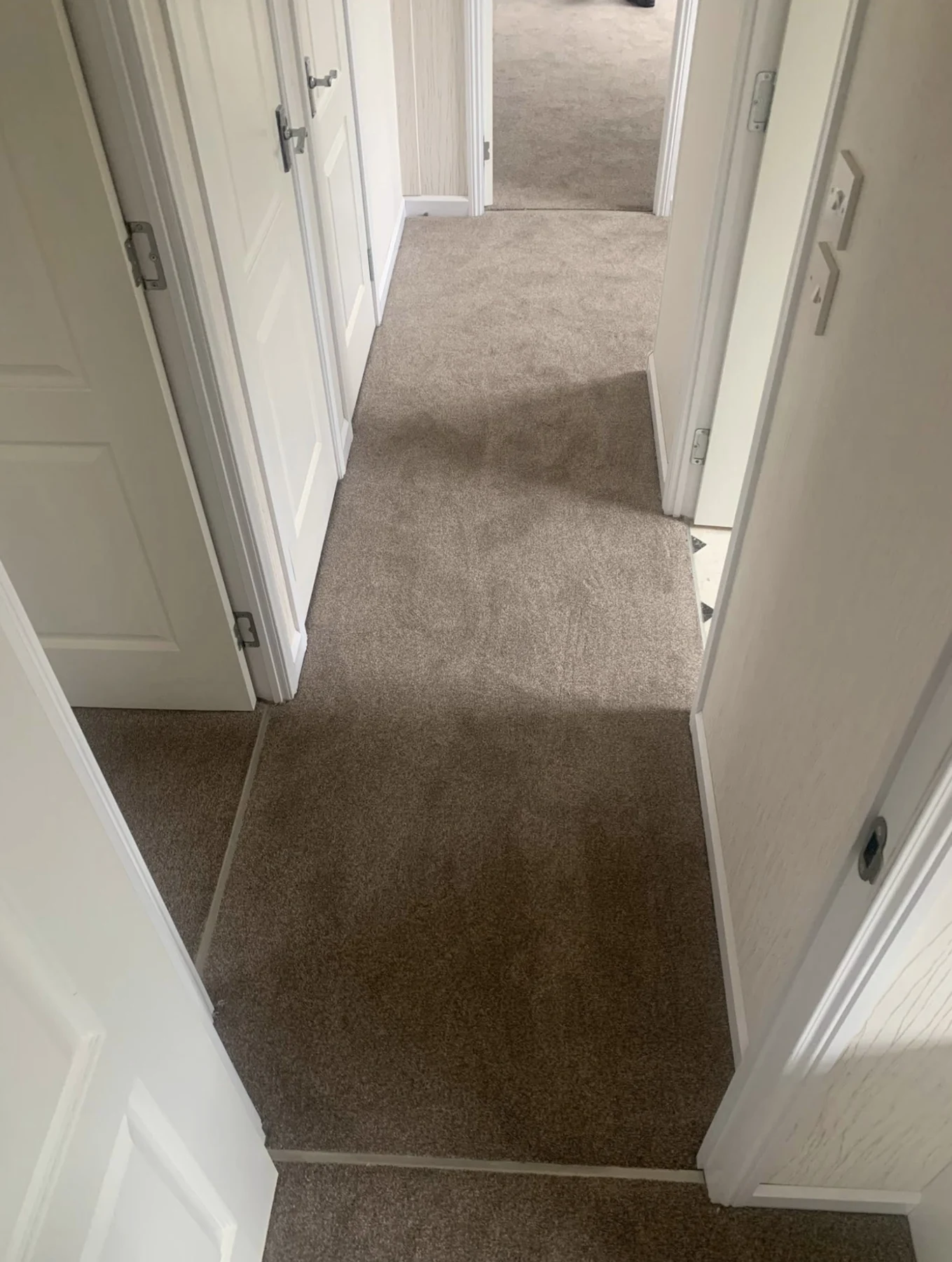 Carpet fitted along a home hallway