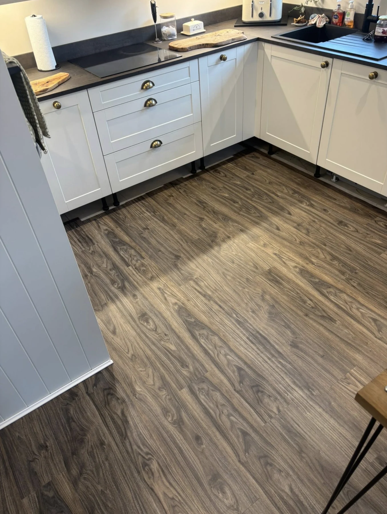 Wood-effect laminate flooring fitted in a kitchen