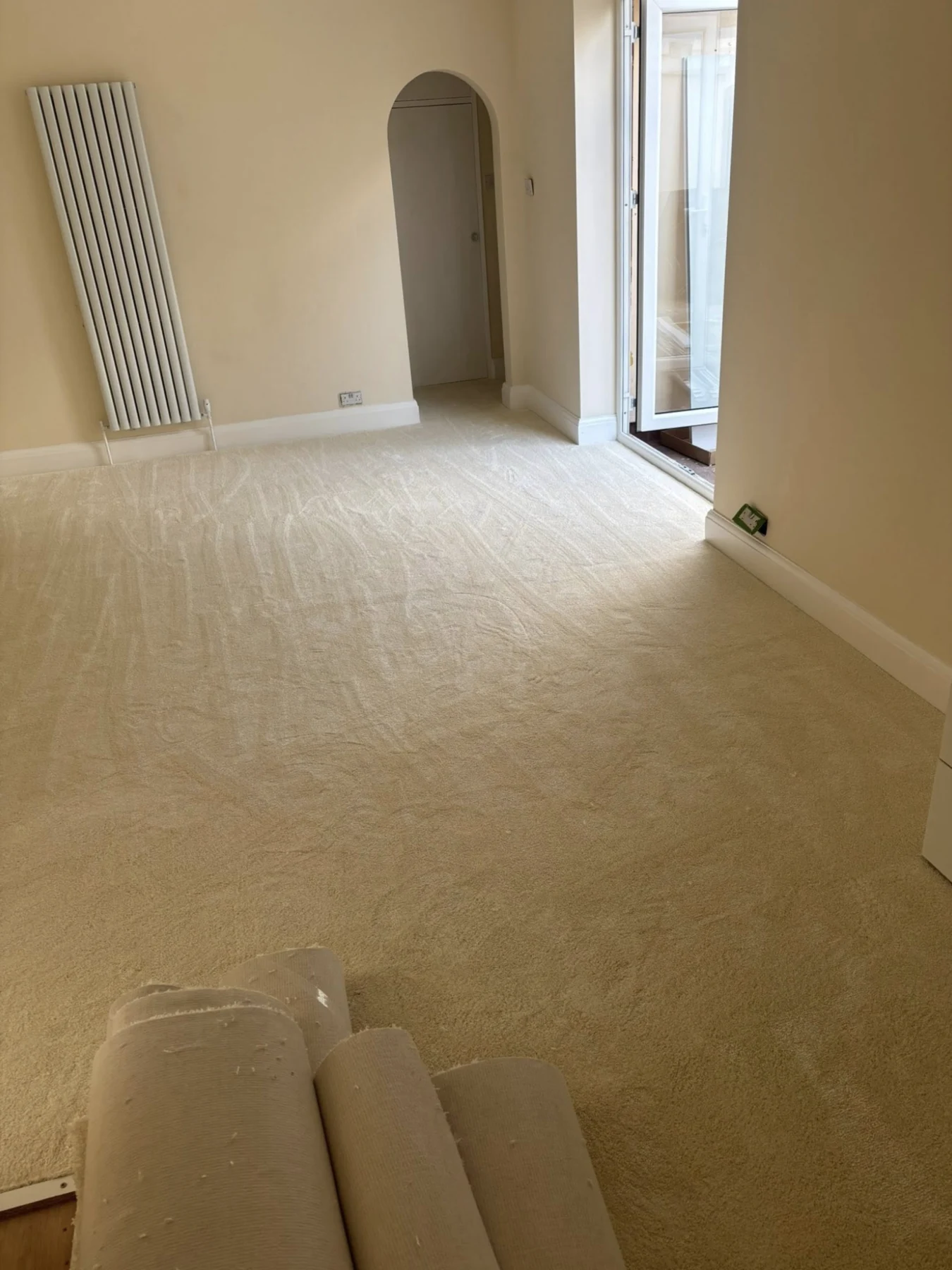 Soft cream carpet fitted throughout a light-filled living room